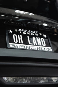 Black license plate frame with Bad Fast lettering, fits standard US plates